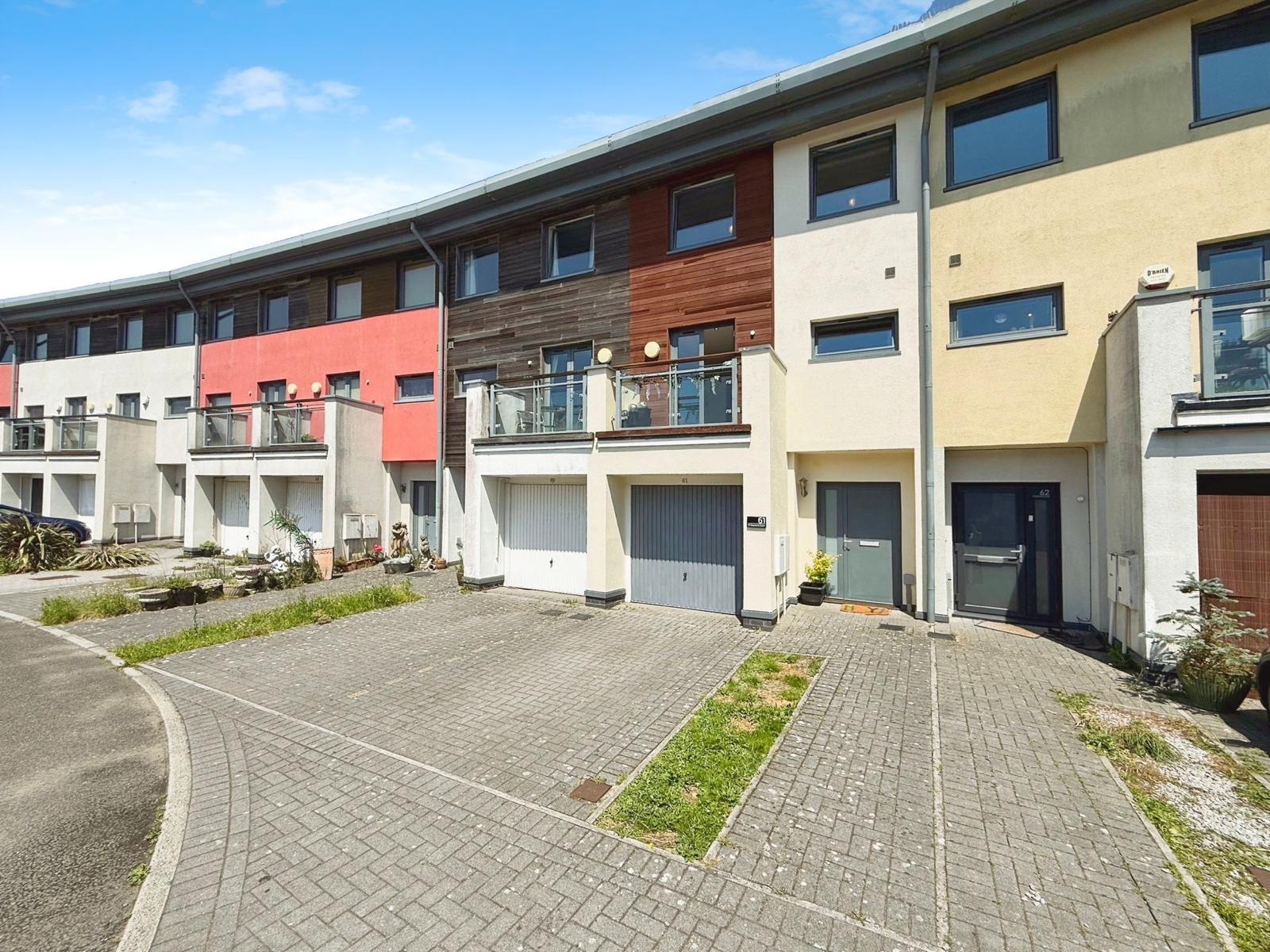 Front exterior of the St Stephens Court townhouse with garage and driveway